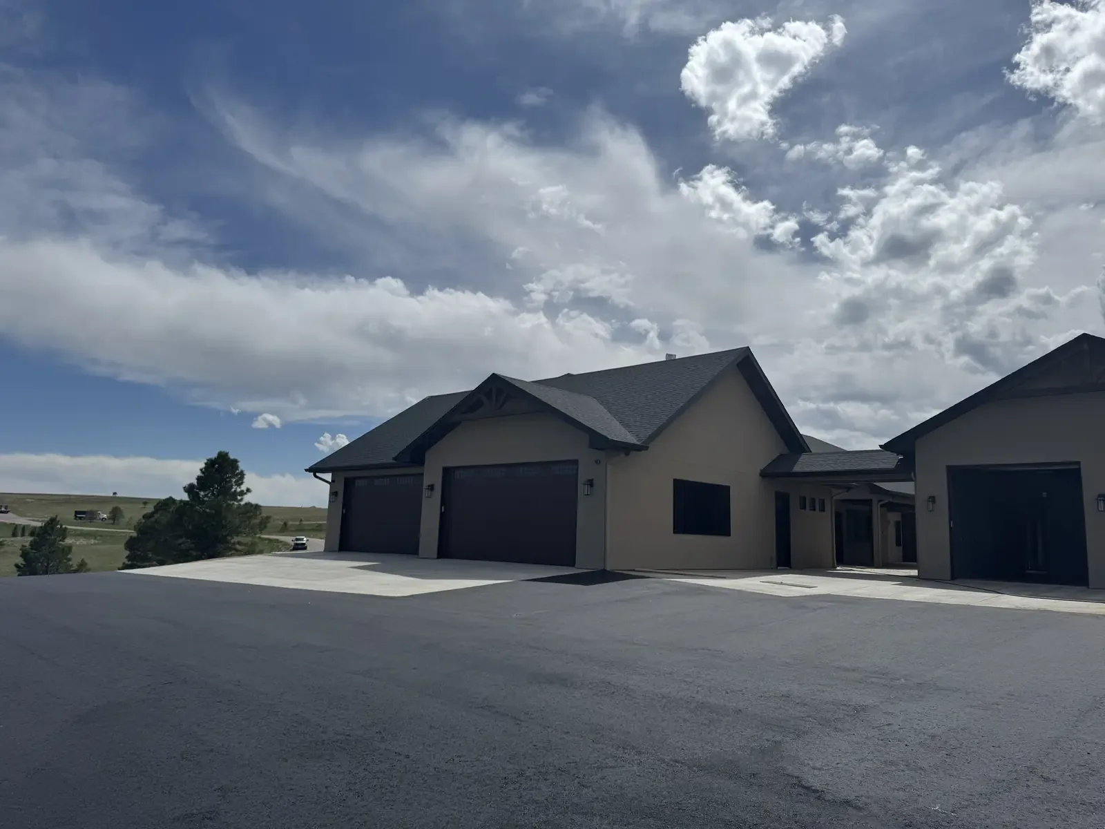 Wide new asphalt parking apron at a commercial building — near Denver, CO