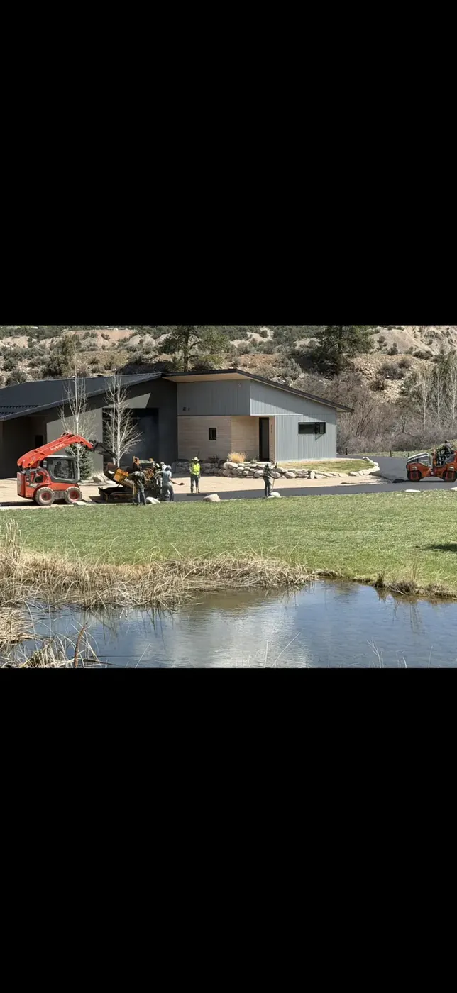 Excavation and drainage work beside a pond on a property