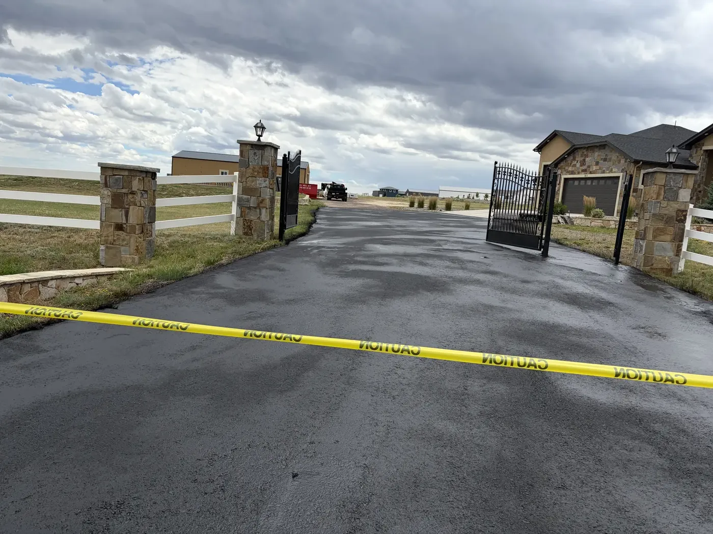 Seal coated entrance drive taped off at a gated property