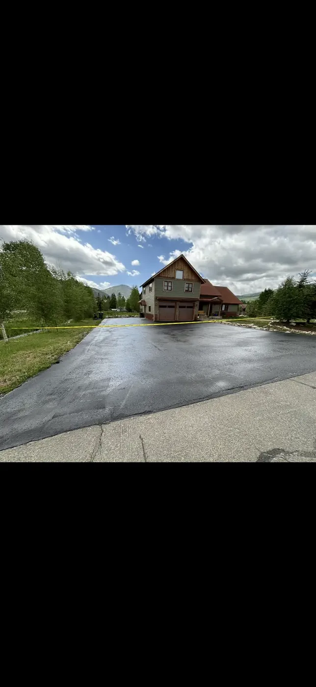 Freshly seal coated lot drying in front of a timber barn