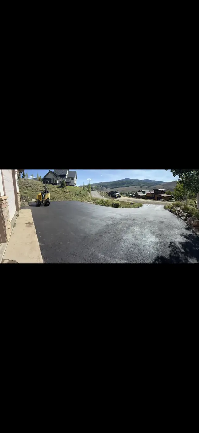 Skid steer shaping the sub grade before asphalt goes down