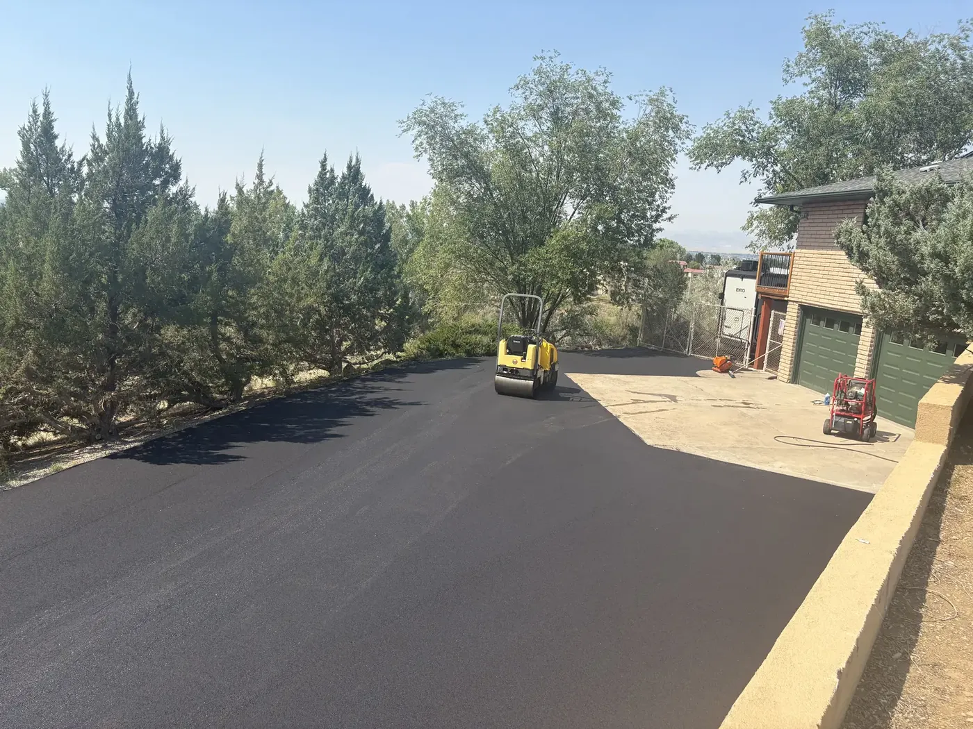 Roller compacting fresh asphalt on a commercial lot