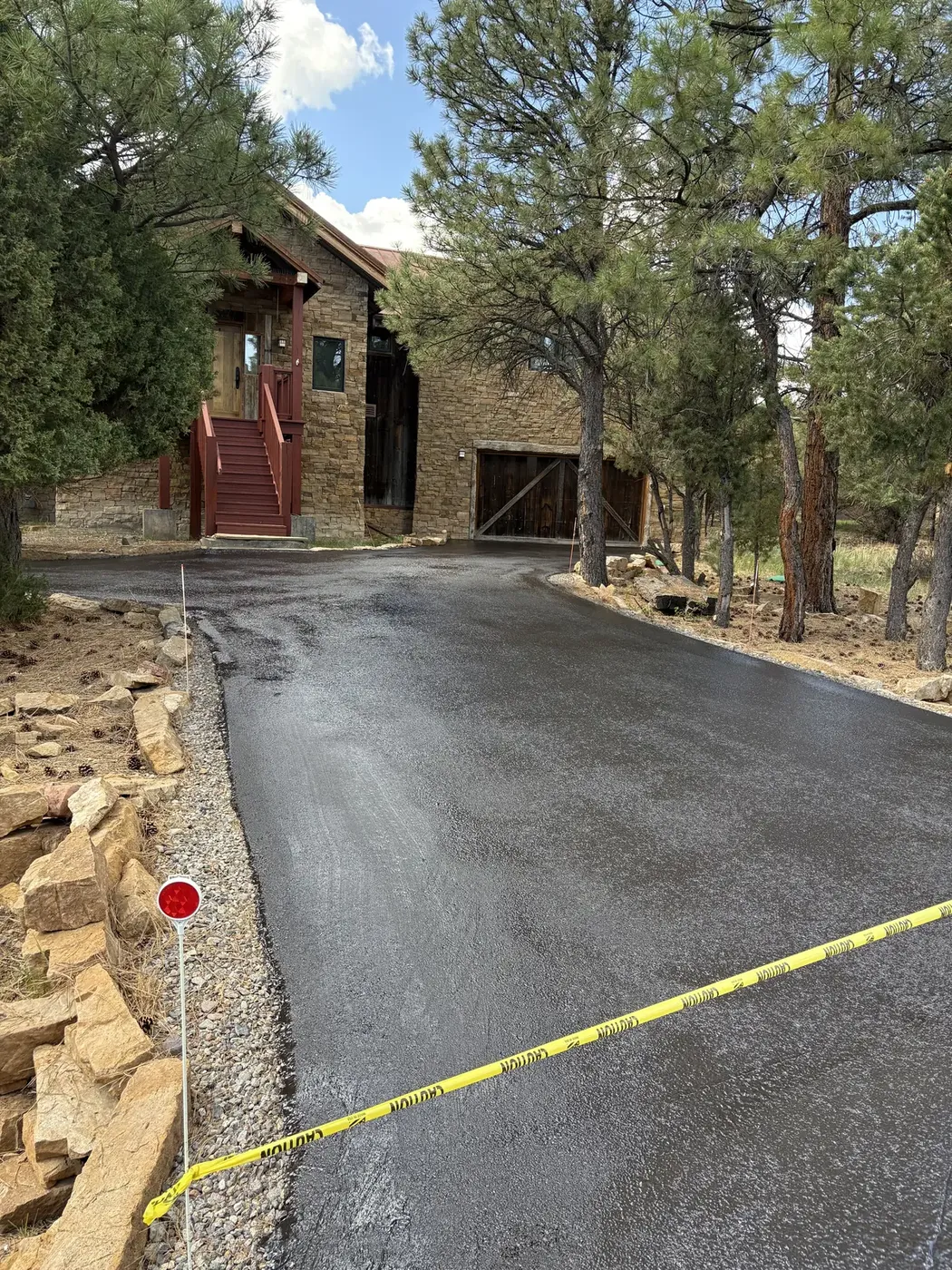 Wet seal coat curing on a driveway at a stone mountain home