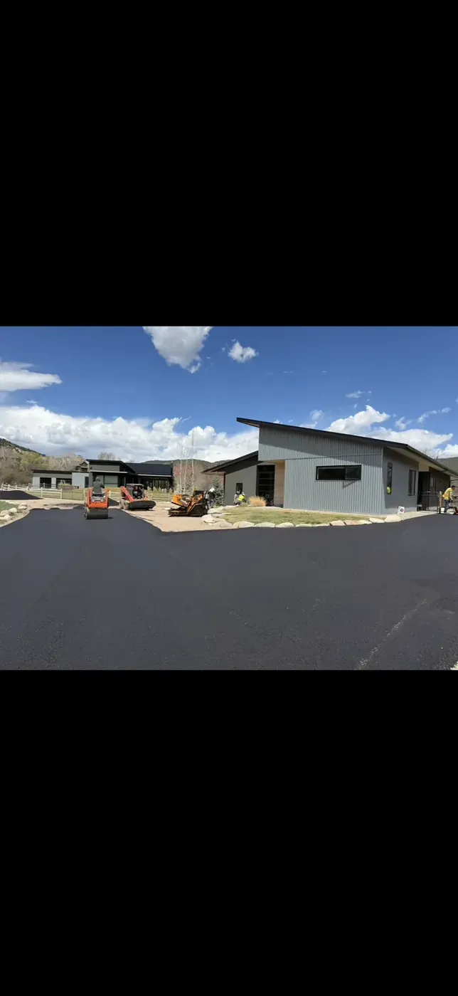 Fresh asphalt driveway at a newly built modern home