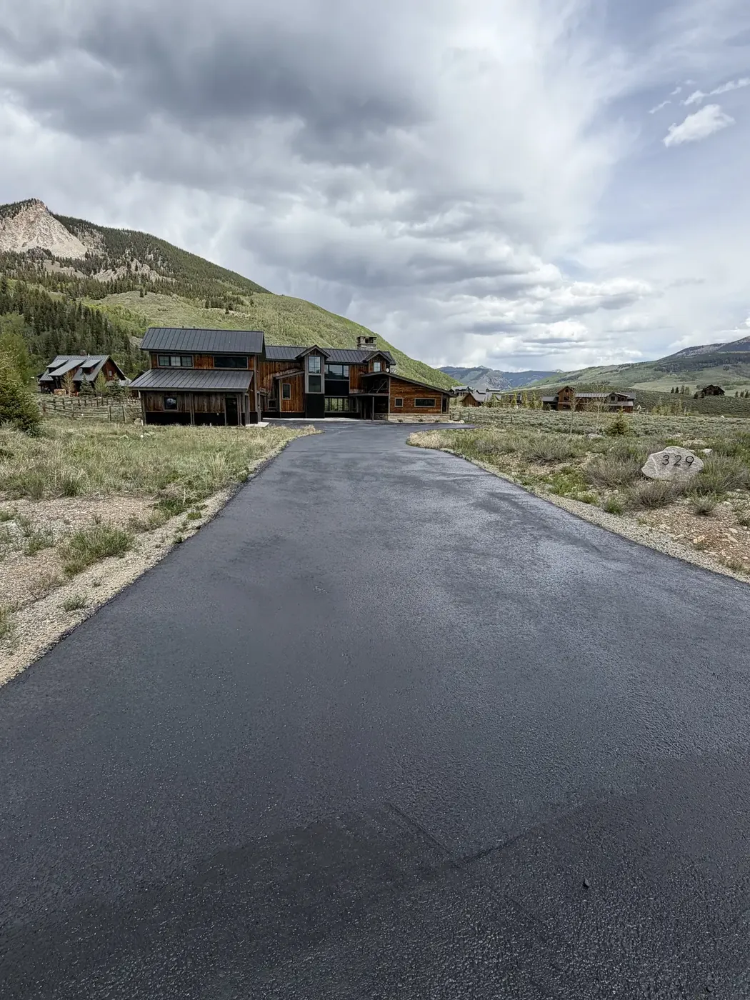 Wide new asphalt driveway at a modern mountain home