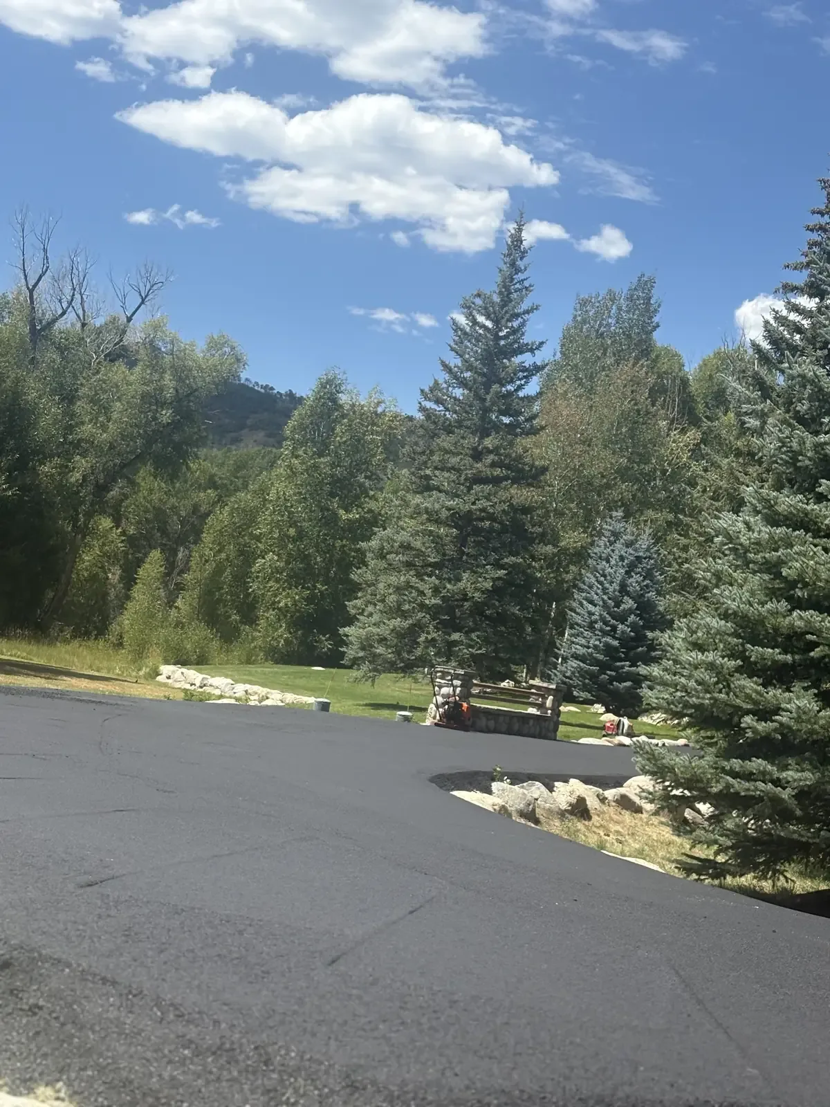 Wide new asphalt drive with a mountain backdrop — near Monument, CO